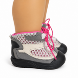 A pair of 18-inch doll hiking boots with gray, white, and black panels, featuring bright pink laces and a pink inner lining, shown on a doll's legs against a white background.