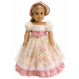An 18-inch blonde doll wearing a vintage-style pink-and-cream dress with floral patterns, ruffles, and a matching bonnet.