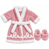 An 18-inch doll's pink plush robe with white trim and a matching white belt, shown with pink plush slippers on a plain white background.