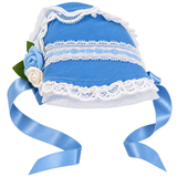 An 18-inch doll's light blue bonnet-style hat with white lace trim, decorative blue-and-white flowers, and long light blue ribbon ties, shown on a plain white background.