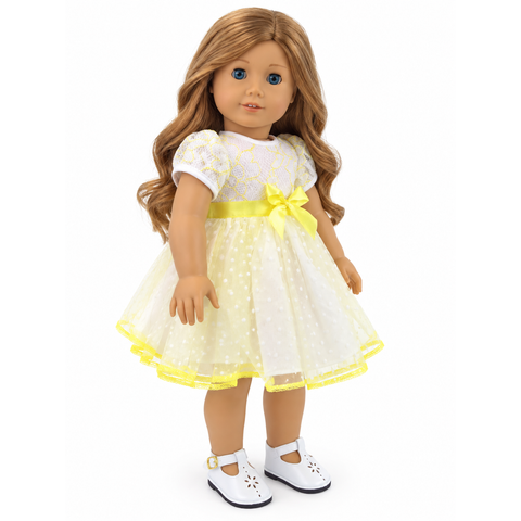 18-inch doll wearing a white and yellow lace polka dot dress with floral lace bodice, yellow satin bow, and dotted tulle skirt.
