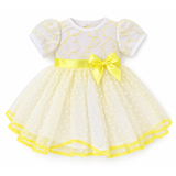 A white and yellow lace polka dot dress with floral lace bodice, yellow satin bow, and dotted tulle skirt for an 18-inch doll.