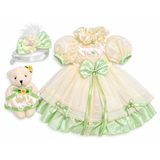 A yellow and green silk dress with tulle, satin bow, pearl detailing, floral headband, and matching teddy bear for an 18-inch doll.