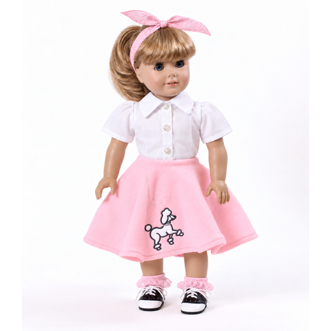 An 18-inch doll with blonde hair with a pink bow, wearing a white short-sleeve collared shirt and a pink skirt with a white poodle embroidery, paired with pink ruffled socks and black-and-white saddle shoes, on a white background.