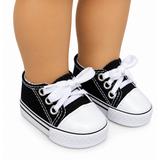 Black-and-white canvas low-top sneakers with white laces and white rubber soles, shown on an 18-inch doll's feet against a white background.