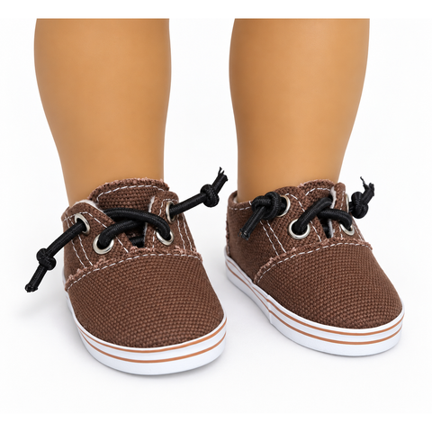 Brown canvas no-tie shoes for 18-inch dolls with black laces, silver-tone eyelets, white stitching, and white striped soles.