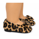 A pair of 18-inch doll's fuzzy leopard-print flats with matching bow details, shown on a doll's feet against a white background.