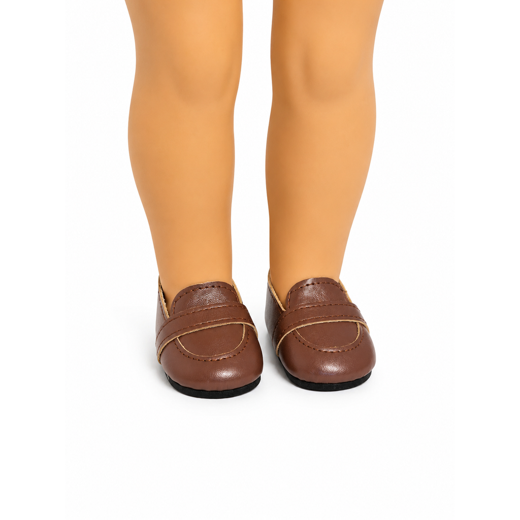 A pair of brown faux-leather loafers with a decorative strap across the vamp, shown on an 18-inch doll's legs against a white background.