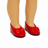 Red patent leather-style bow flats with satin bows and black soles, shown on an 18-inch doll against a clean white background.