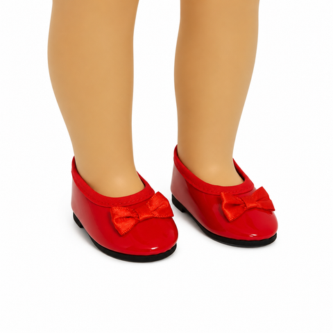 Red patent leather-style bow flats with satin bows and black soles, shown on an 18-inch doll against a clean white background.