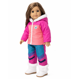 An 18-inch doll with brown hair, wearing a bright pink and coral puffer jacket with white faux-fur trim, matching blue-and-purple patterned snow pants, photographed against a plain white background.